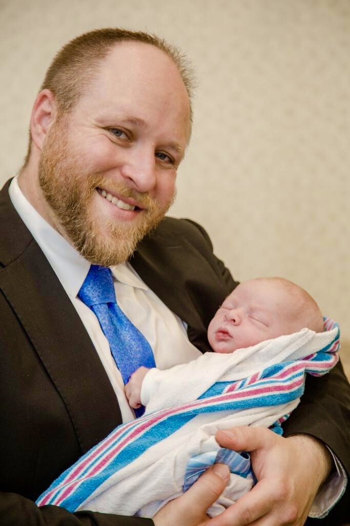 Rabbi Shmuel Katz holding baby